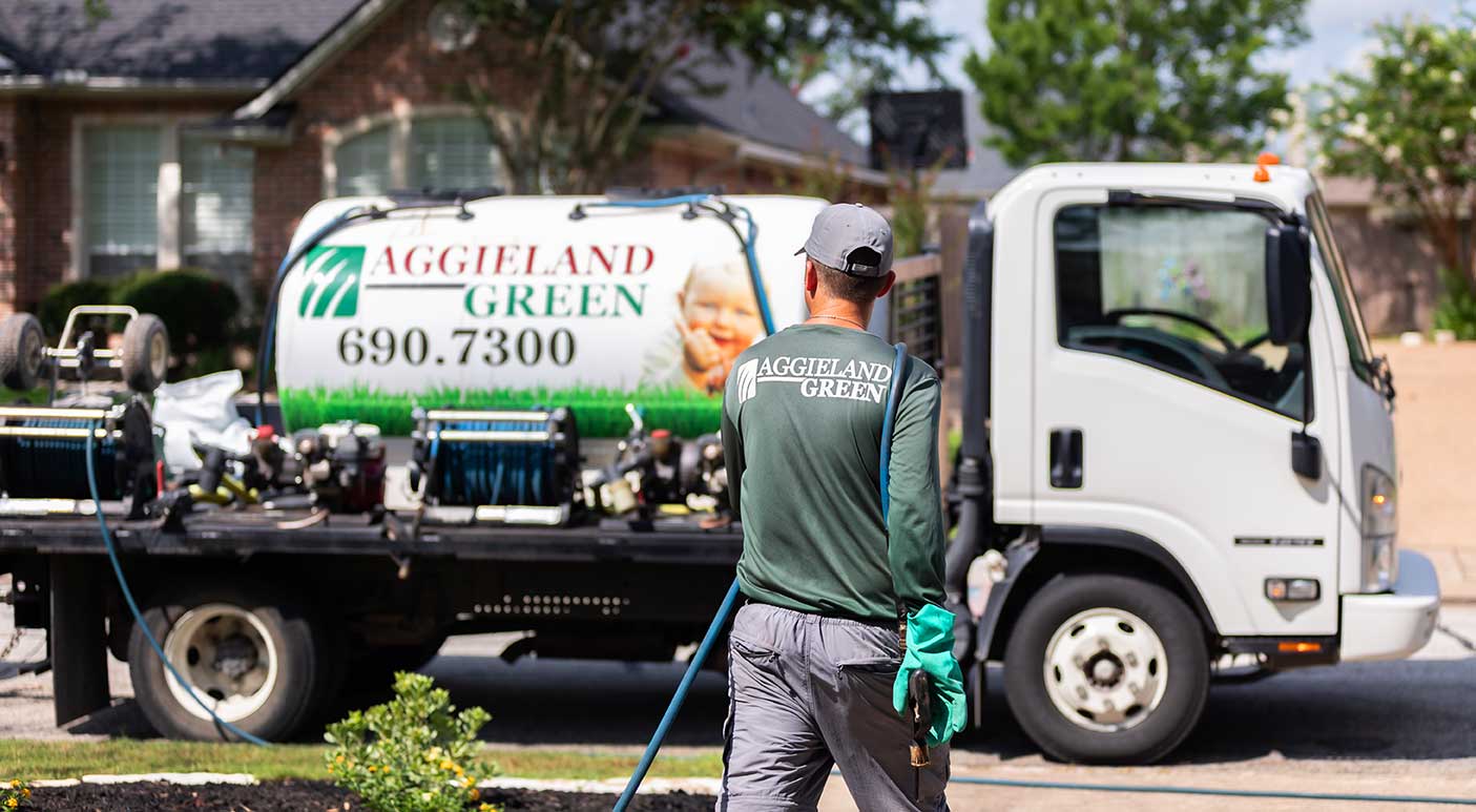 aggieland-green-homepage-hero local lawn care company aggieland green treating a texas lawn